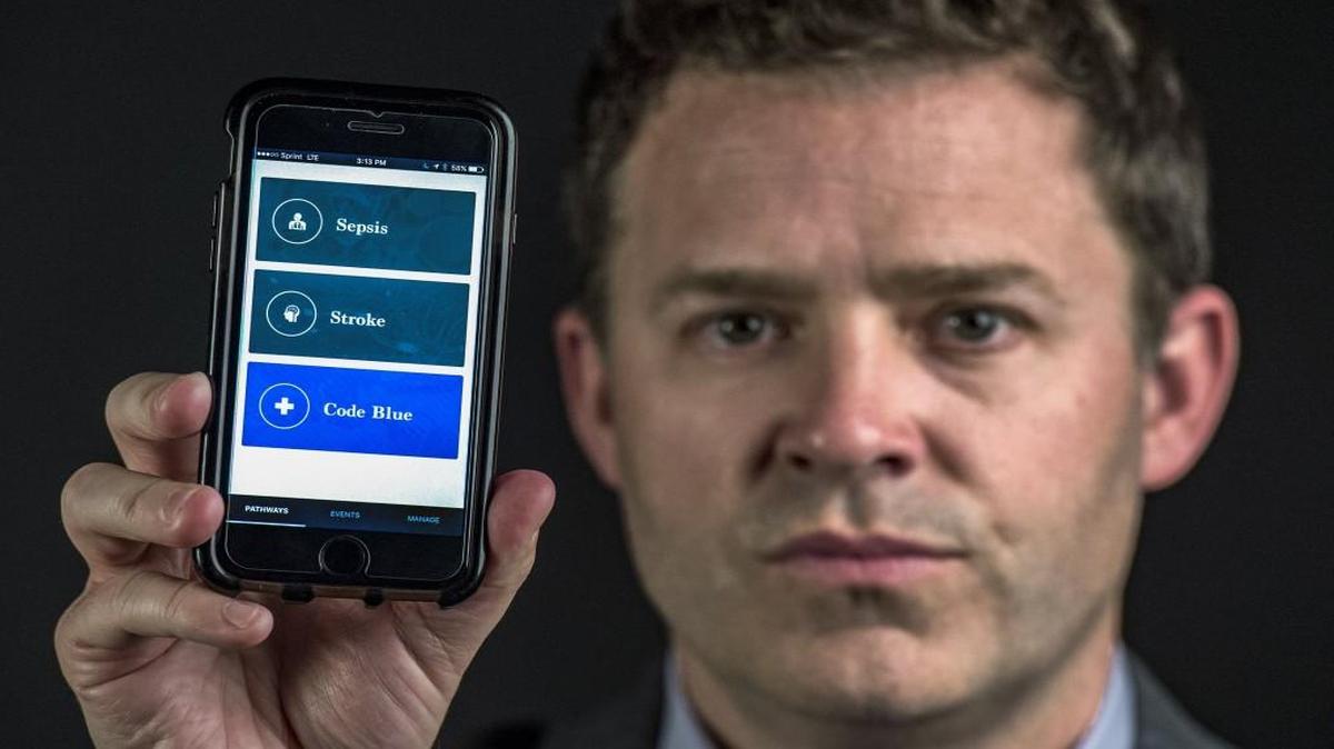 Jeff Dunn, CEO of Redivus Health, on Tuesday held up a phone displaying his company’s app aimed at medical professionals. The app provides step-by-step expert guidance for clinicians on treating sepsis, stroke and cardiac arrest.