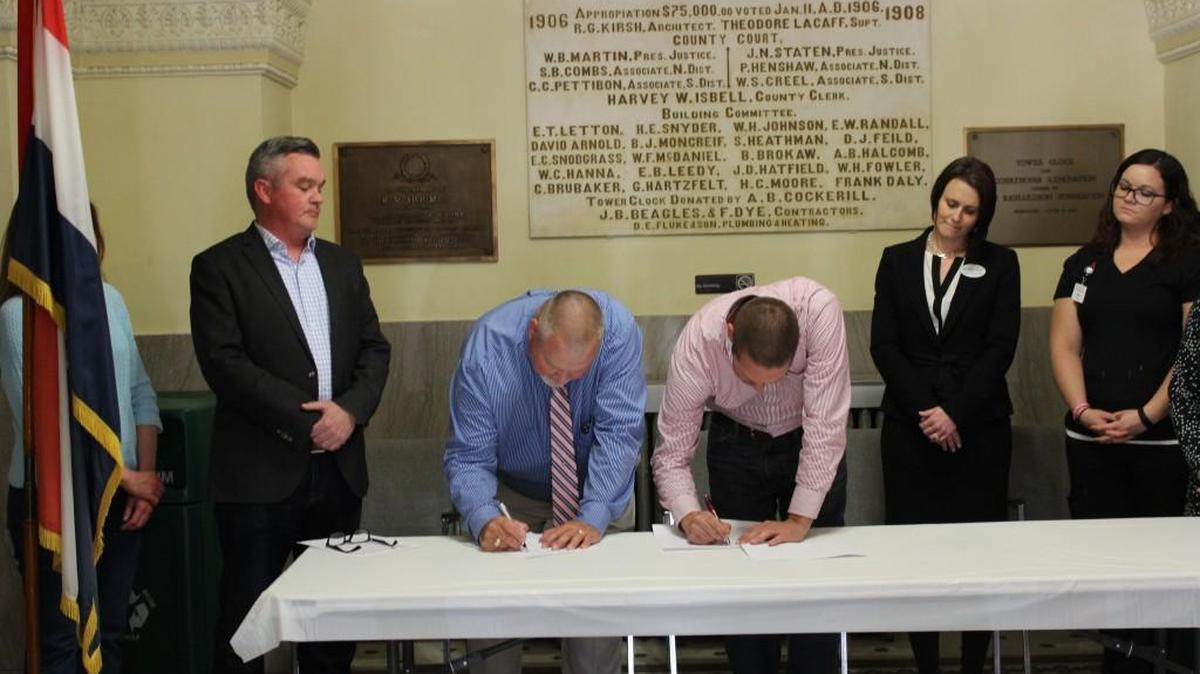 Nevada and Vernon County officials signed an ordinance Wednesday to join a Prescription Drug Monitoring Program network of several cities and counties in Missouri. Nevada City Manager J.D. Kehrman, (left to right), Nevada Mayor Brian Leonard, Vernon County Presiding Commissioner Joe Hardin, Heartland Behavioral Health Services CEO Alyson Harder, and Tasha Triplett with the Vernon County Health Department participated in the signing ceremony.