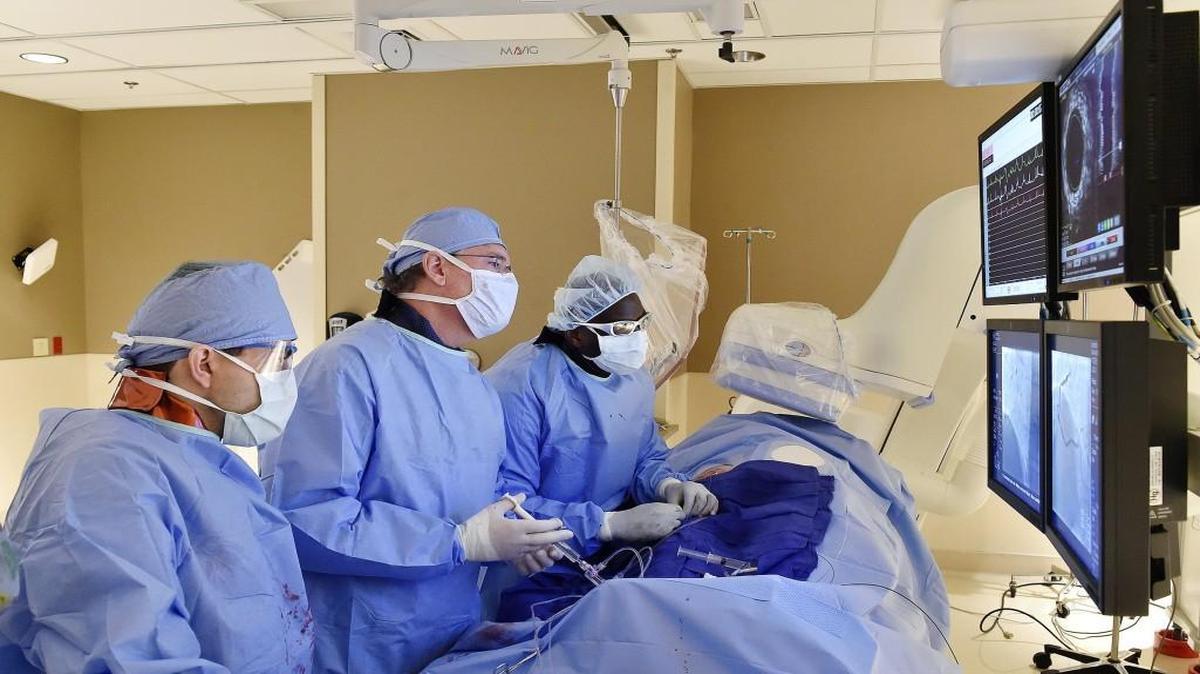 Kenneth Huber (center), a cardiologist with St. Luke’s Mid America Heart Institute, inserted a coronary stent in a patient with a blocked artery. Fellows Abdul-Rahman Abdel-Karim (left) and Clarence Findley assisted him. Angioplasties still can save lives during heart attacks.