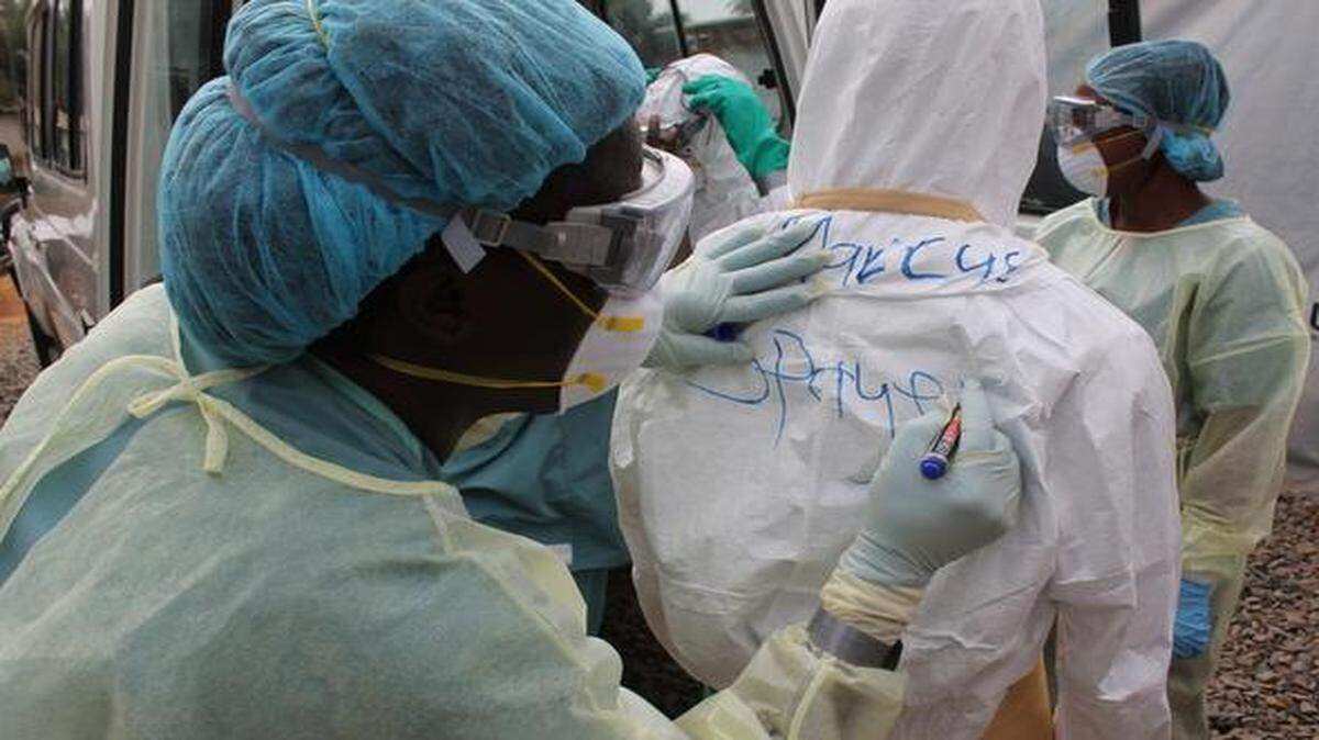 
Health workers prepare for a shift at the Heart to Heart International treatment unit in Liberia.

