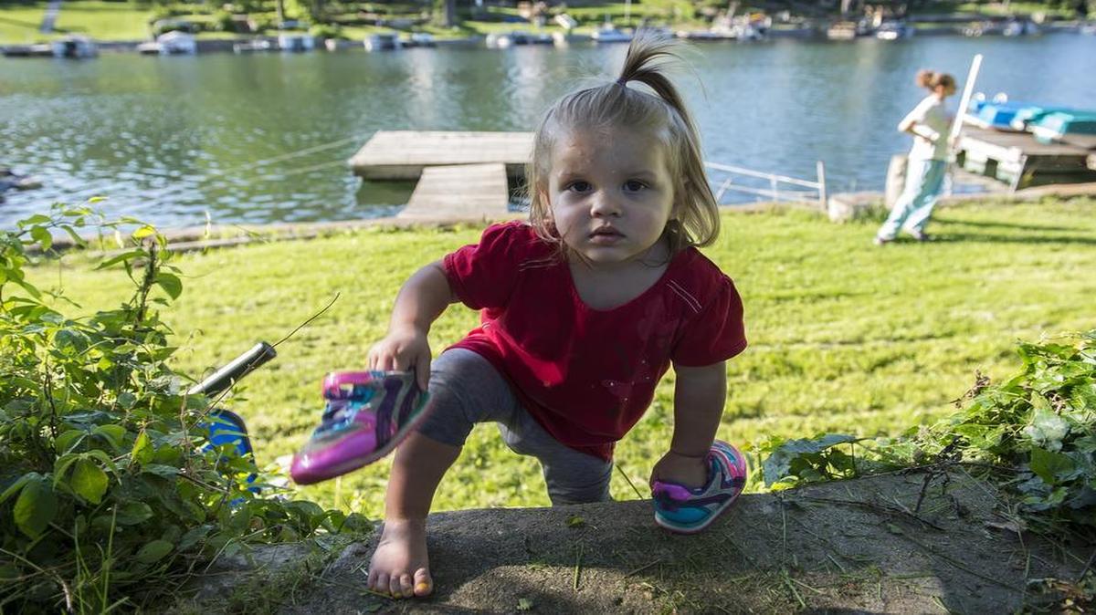
When Kira Walker was born with hypoglycemia, doctors turned to genome sequencing to pinpoint the cause. A mutated gene was making parts of Kira’s pancreas hyperactive. Surgery remedied the problem. Now nearly 2, Kira is healthy enough to climb steps on the shore of Lake Waukomis behind her home with her mother, Amanda Webb.

