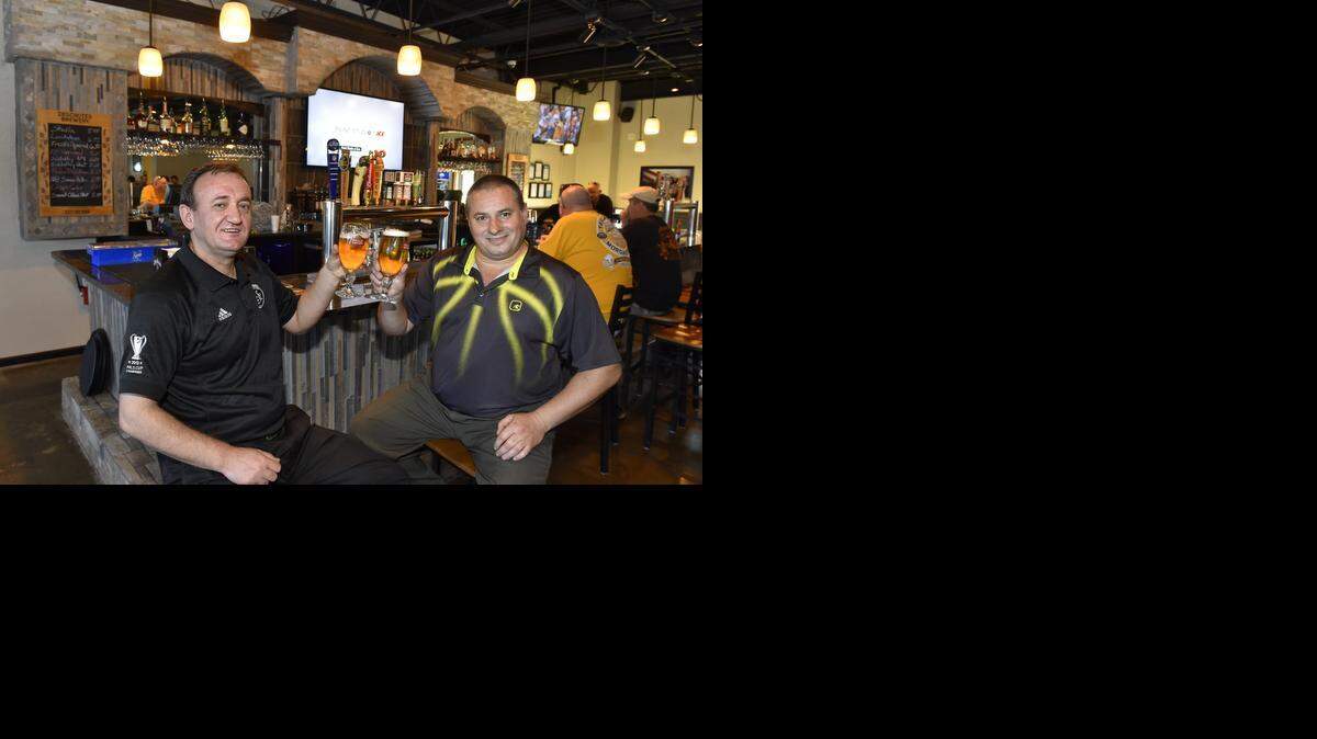 Nick Broja (left) and Nino Sokoli opened Nick & Nino’s Pub at 10022 N.W. Ambassador Drive.