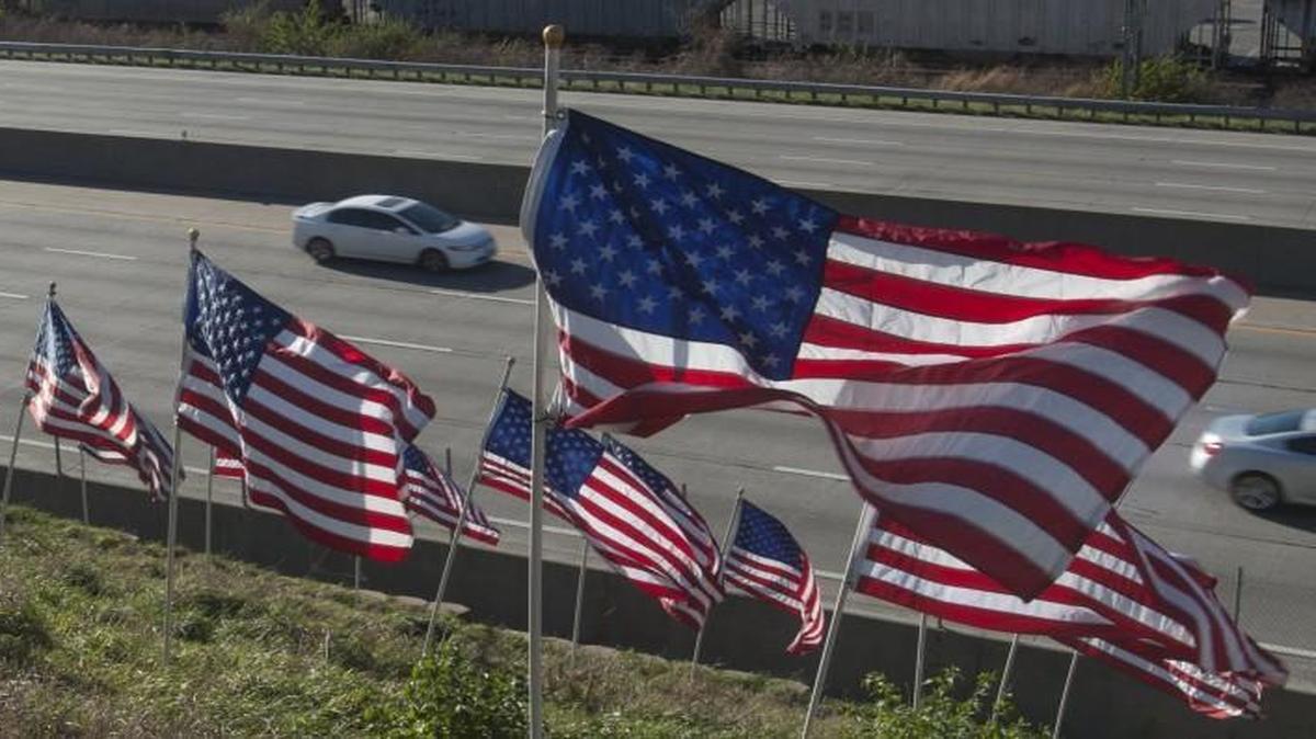 A hill of American flags along Interstate 35 by Merrian Town Center honors veterans each year.
