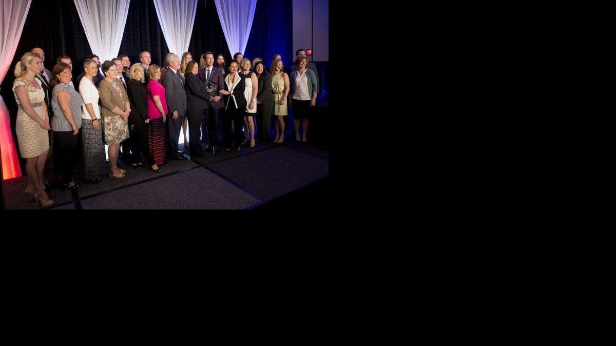 
Bishop-McCann was named Small Business of the Year by the Greater Kansas City Chamber of Commerce during a luncheon  Thursday,  at the Sheraton Hotel Crown Center. Company employees gathered around company founder and CEO, Dan Nilsen (with trophy), for a picture after the award.



