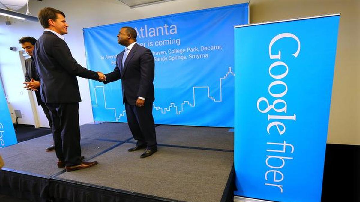 
Tom Lowry (left), head of the Google Atlanta office, shook hands with Mayor Kasim Reed at the conclusion of a news conference Tuesday announcing the launch of Google Fiber in Atlanta.
