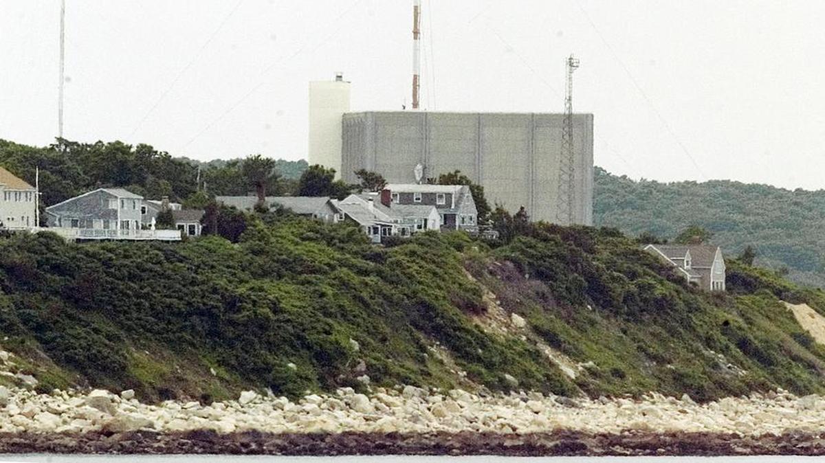 
A portion of the Pilgrim Nuclear Power Station sits beyond houses along the coast of Cape Cod Bay in Plymouth, Mass. 
