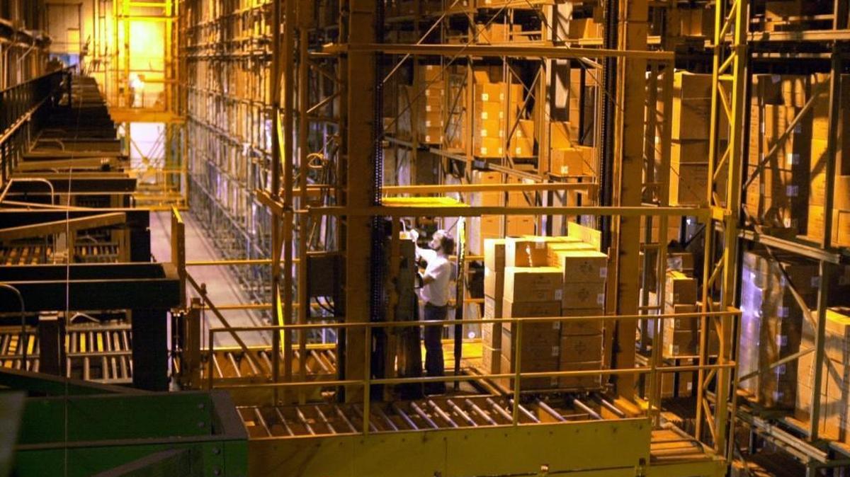 Employees pull cartons of stock from the Hallmark Cards warehouse, using computer-automated stacker cranes at the company’s distribution center in Liberty.