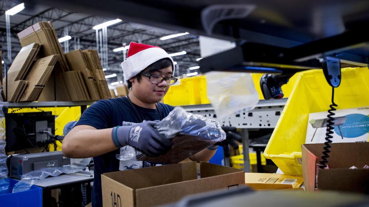 An Amazon.com employee loaded merchandise into a box at the company’s fulfillment center in Tracy, Calif., ahead of last year’s Cyber Monday.