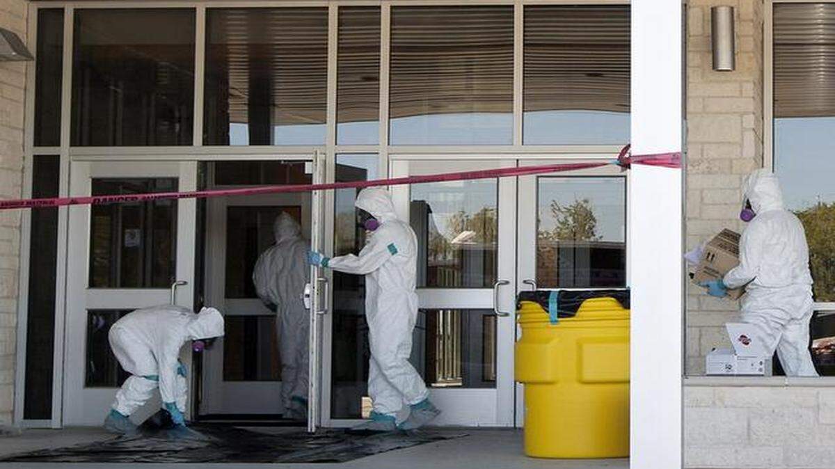 
Workers on Friday prepared to disinfect North Belton Middle School in Belton, Texas. A Texas school district has temporarily closed three of its campuses after a family of four, including two students from the district, traveled on the same flight as a nurse who has since been diagnosed with Ebola.
