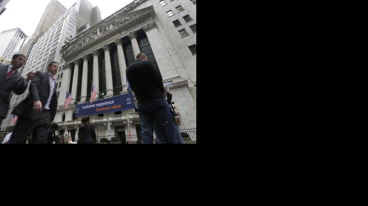 
People pass the New York Stock Exchange in New York. 
