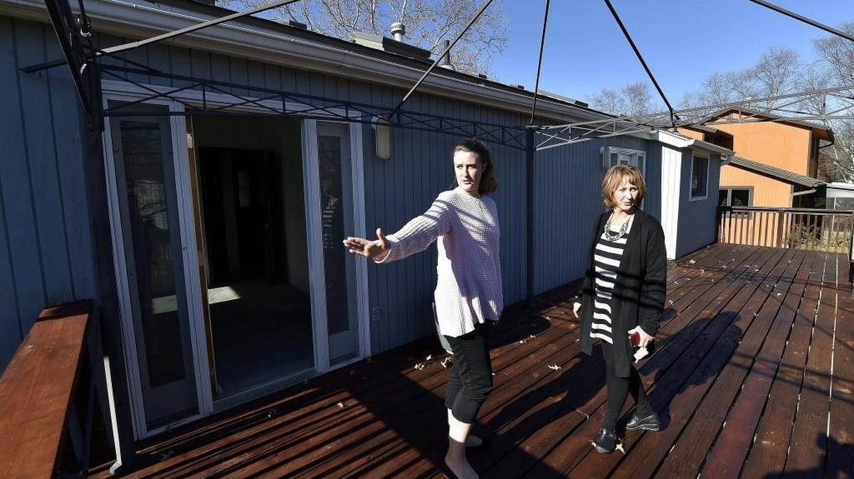 Beverly Moore (right), a real estate agent with ReeceNichols, showed a home for sale with prospective buyer Rebecca Meeker, from Kansas City, North, on last week in Lenexa. At meeting this week, the Federal Reserve is likely to increase interest rates.