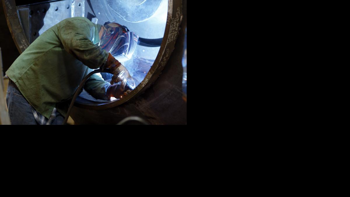 
A man welds parts in fans for industrial ventilation systems at the Robinson Fans Inc. plant in Harmony, Pa. 
