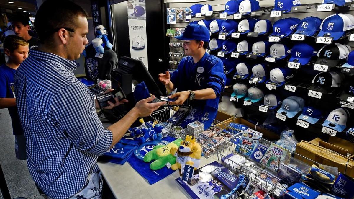 
Spurred by record attendance, three times more Royals merchandise was sold at Kauffman Stadium this year than last. Michael Ramos of Knob Noster, Mo., purchased a cap during a recent game.

