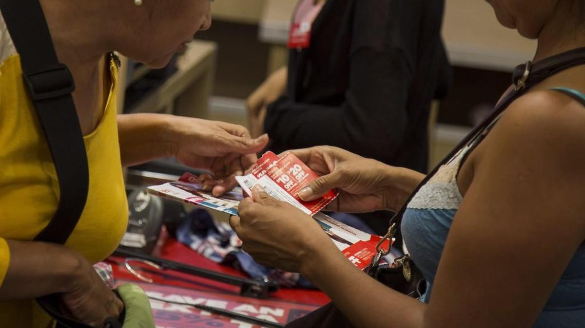 
Customers use coupons while purchasing items at the checkout counter of a J.C. Penney Co. store.
