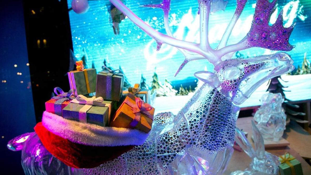 A reindeer sculpture carries a load of gift-wrapped presents in a holiday window display at Macy's in New York.