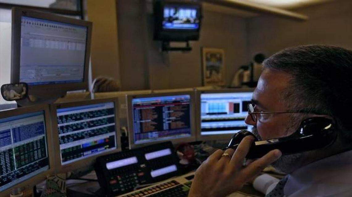 Investment outflows cut into earnings at Waddell and Reed Financial in the fourth quarter. This is the firm’s trading desk.