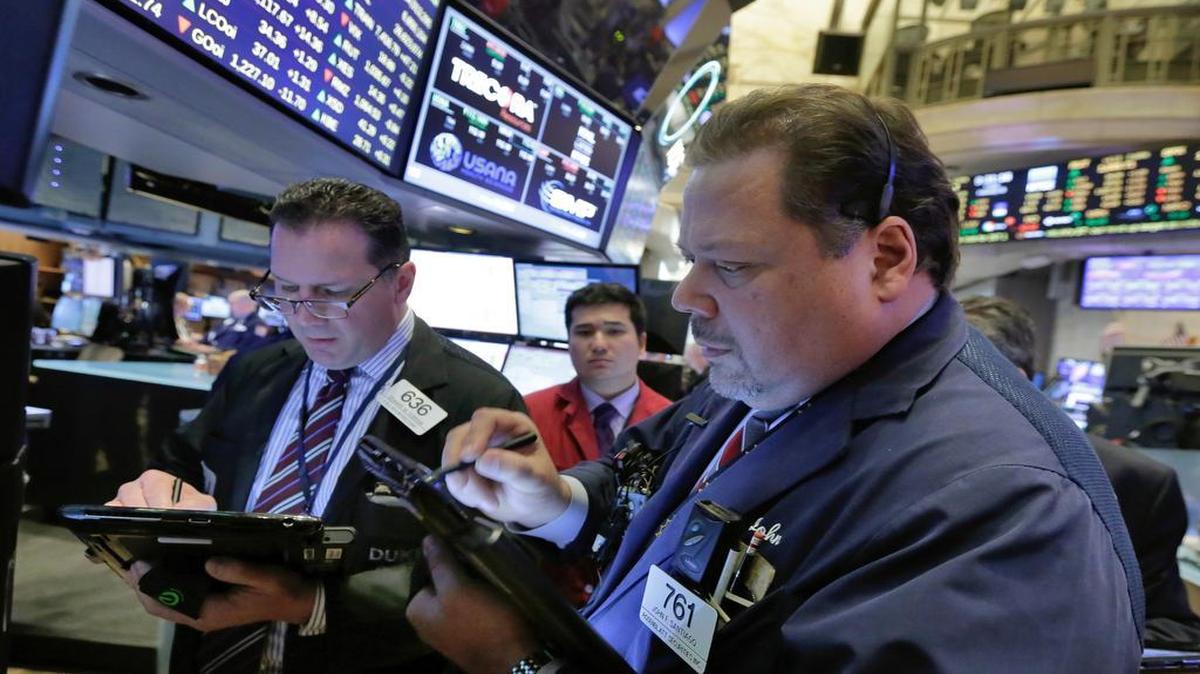 Edward Curran (left) and John Santiago worked Friday on the floor of the New York Stock Exchange.