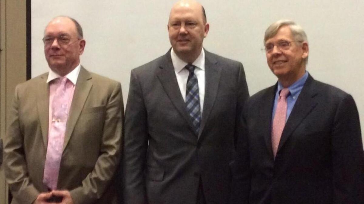 Economists Chris Kuehl (left) and David Crowe (right) on Wednesday addressed the Home Builders Association of Greater Kansas City, along with association president Brenner Holland (center) of Hunt Midwest.