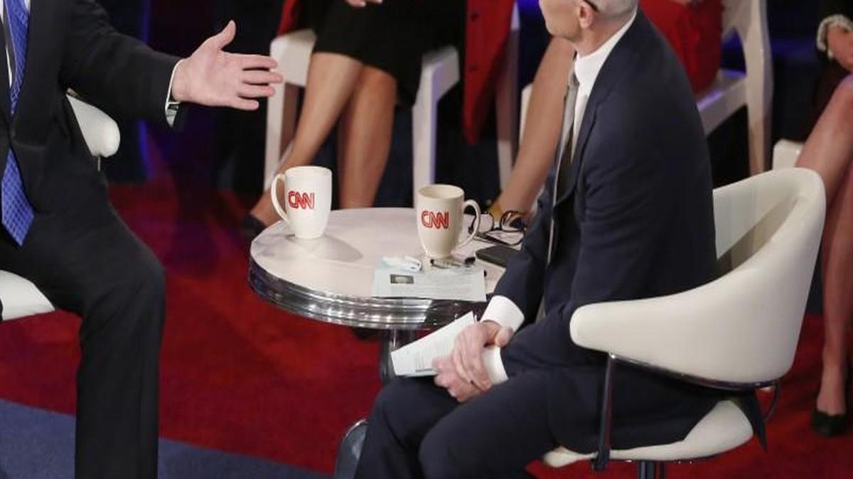 Donald Trump talks with CNN host Anderson Cooper at a televised town hall meeting in Milwaukee.