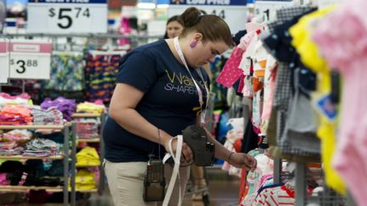 
Mary Bullen, merchandise supervisor of the infant and girls section, makes price changes to clothing at the Wal-Mart Supercenter in Rogers, Ark. 

