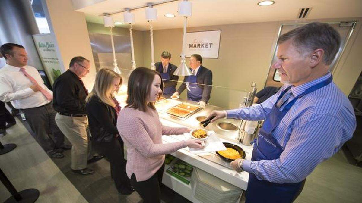 Ray Kowalik, newly promoted to executive vice president, served up cheese Monday to employees during the firm’s 22nd annual Chili Bowl. The event celebrates the anniversary of when the company became employee owned.