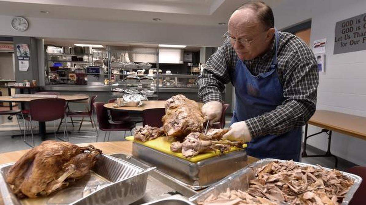 
In preparation for Christmas dinner, volunteer Rick Holzman of Olathe carved away Tuesday afternoon at the Salvation Army, 101 W. Linwood Blvd.
