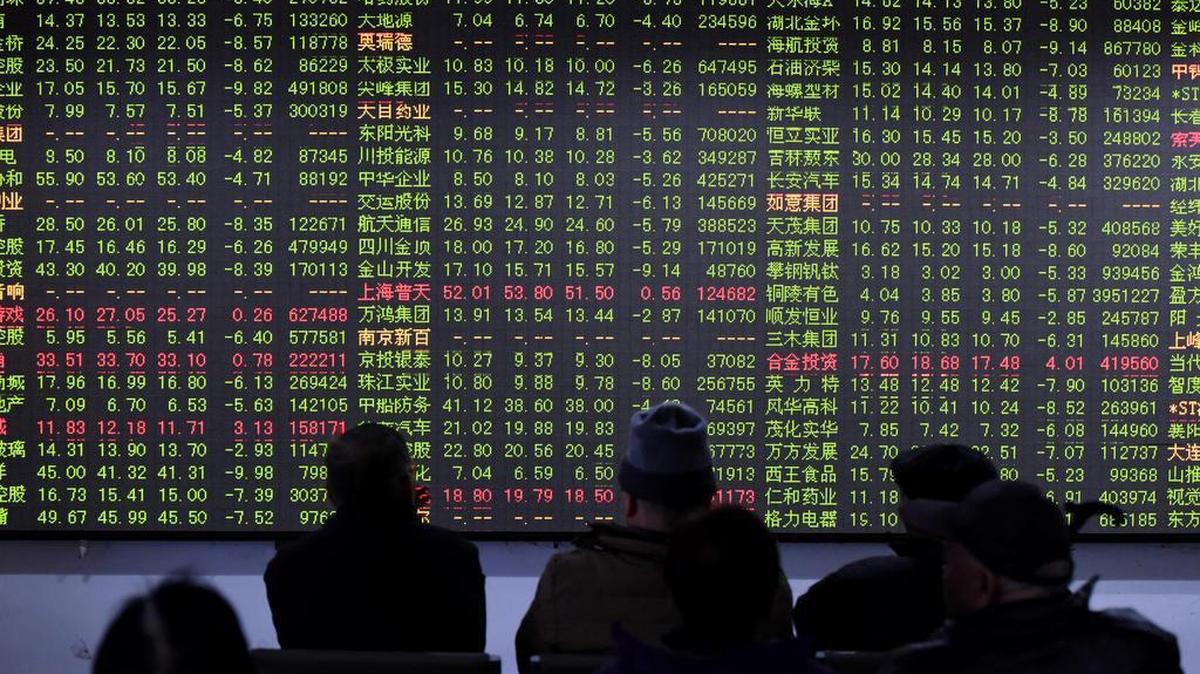 Chinese investors monitored stock prices Friday at a brokerage house. China’s stock market fell sharply Friday as investigations into the securities industry widened to include two top brokerages.