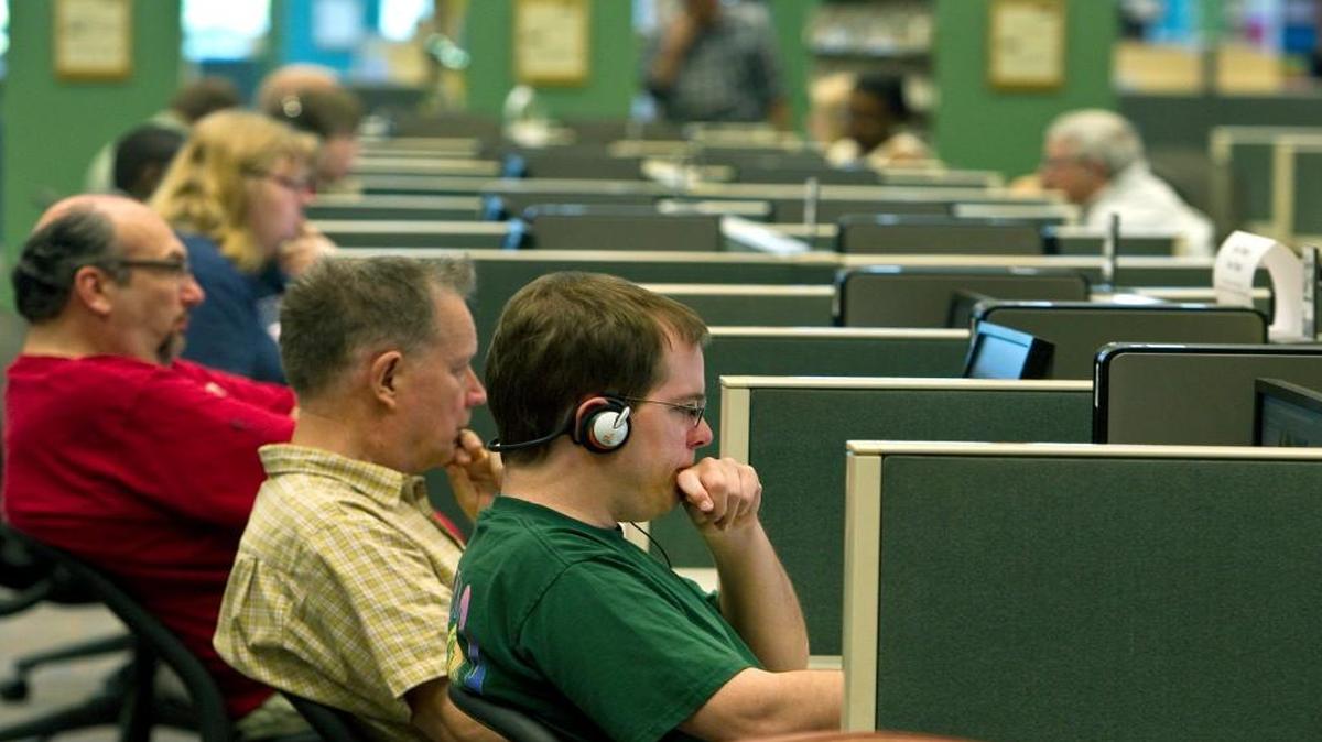 Internet access, like here at the Johnson County Library, has become a popular library service. Should home internet access be seen as being as essential as electricity?