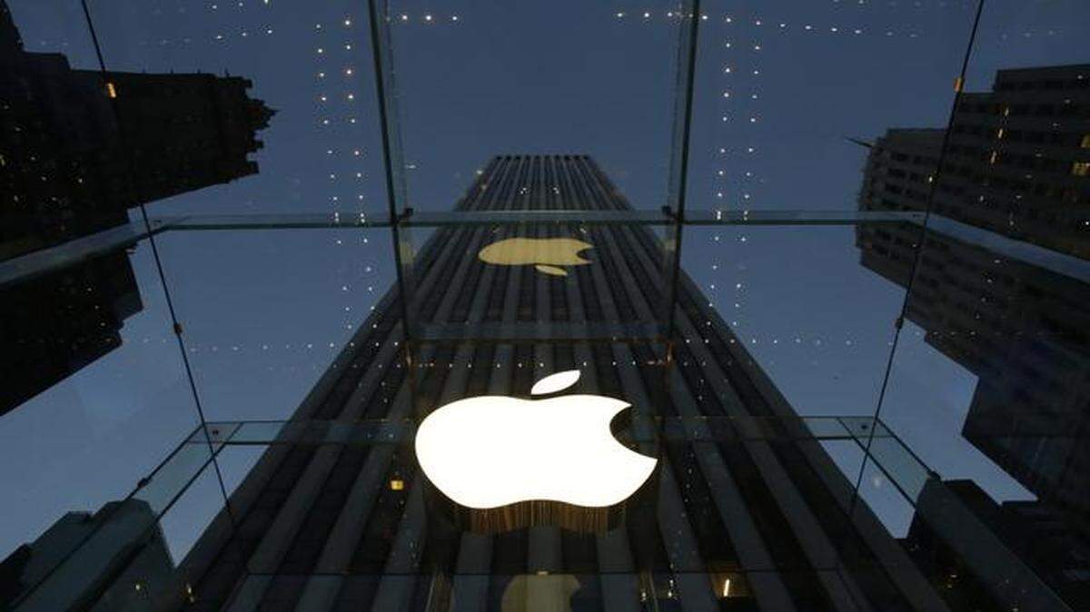 
The Apple logo is illuminated in the entrance to the Fifth Avenue Apple Store in New York.
