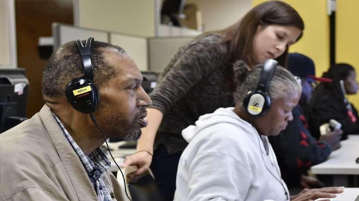 
Literacy Kansas City, where Stewart Carter (left) recently worked with a computer software program, will host one of two area fellows in a Google Inc.-backed program to expand local Internet access. 

