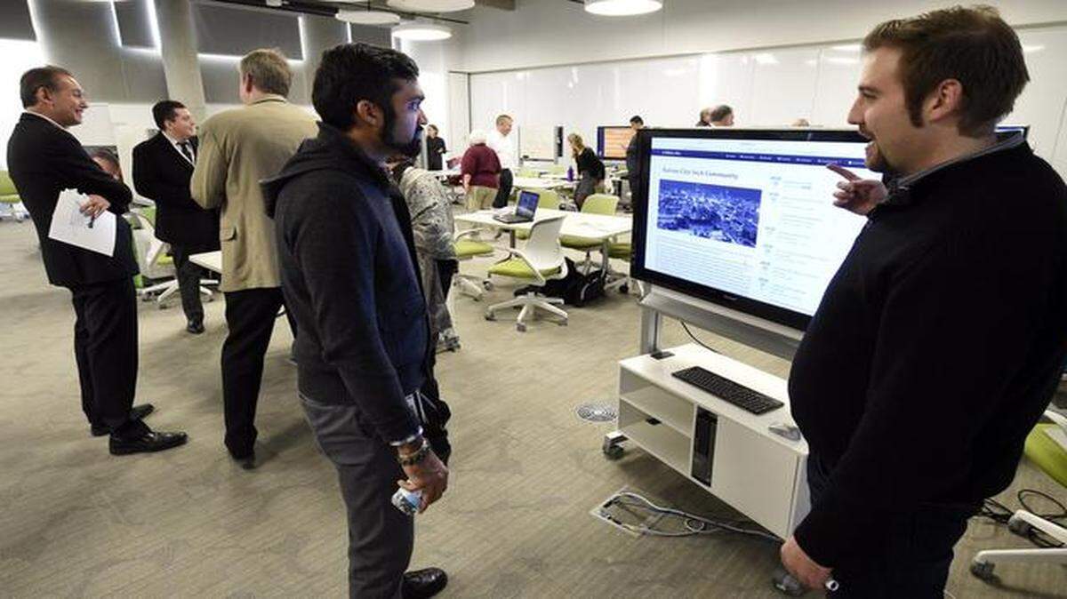 Ilya Tabakh (right), who works for Somametric, an interaction agency, discussed technology with Anurag Patel of the University of Kansas Medical Center at the Gigabit City Summit at the University of Missouri-Kansas City.