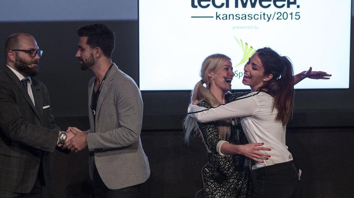 
Drew Solomon (left), co-founder of LaunchKC, shook hands with Scott Hanson, PopBookings co-founder, as Katy Lynch, CEO of TechWeek Inc., hugged Erika Klotz (right), PopBookings co-founder, as the People’s Choice winner. The LaunchKC’s grant competition was part of the Techweek events held this week at Union Station.

