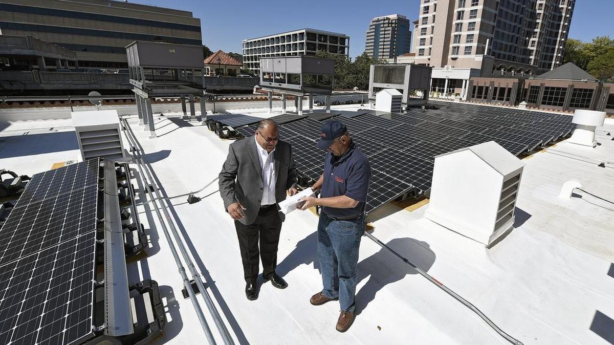 
Ray Ortiz (left), president of Solar Rich Power, and Bob Solger of Solar Design Studio checked on a recently installed array of solar panels on the roof of Unity Temple on the Plaza in Kansas City.
