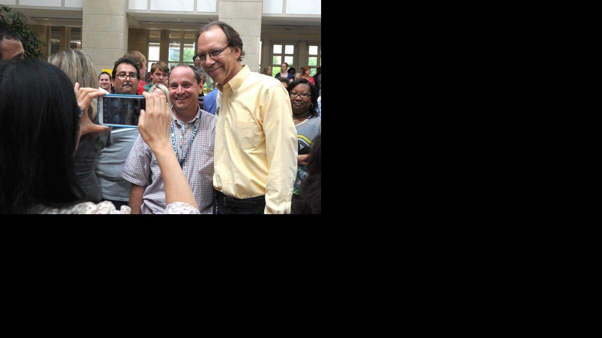 
A Sprint employee gets a photo with exiting Sprint CEO Dan Hesse Friday. 
