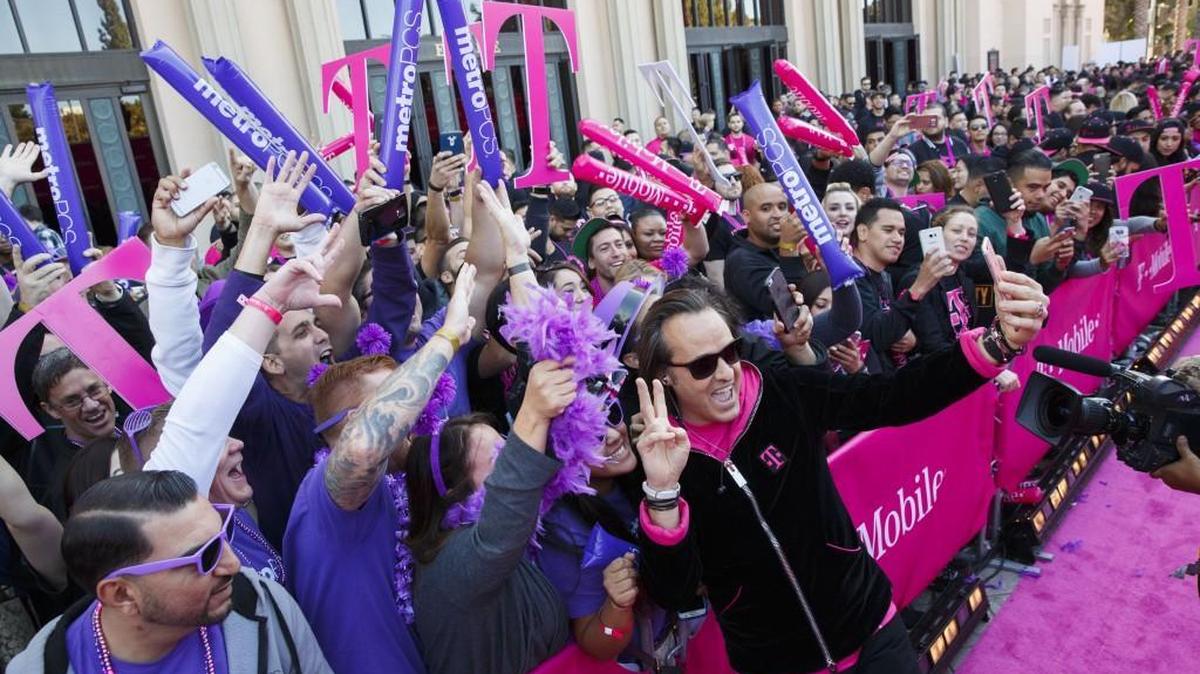 T-Mobile US Inc., whose CEO John Legere is shown here celebrating the launch of a new consumer feature, is once again mentioning its net income in earnings releases.