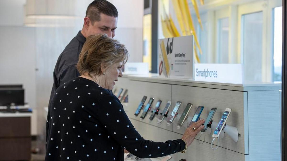 A customer looked at a smartphone at a Sprint store in Palo Alto, Calif.