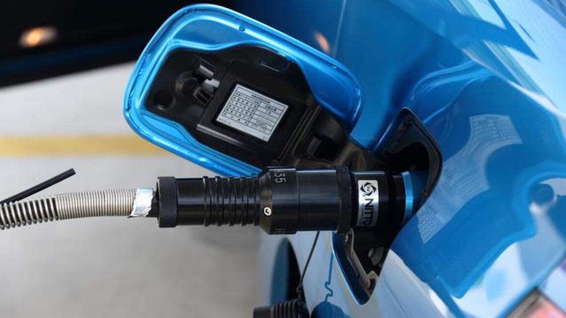 
A Toyota Mirai fuel-cell-powered vehicle is filled with compressed hydrogen at a smart hydrogen fueling station in Tokyo. Toyota will start selling its Mirai fuel cell vehicle next month for $63,000, which Japan will subsidize with the aim of repeating the success of the world’s most popular hybrid. 
