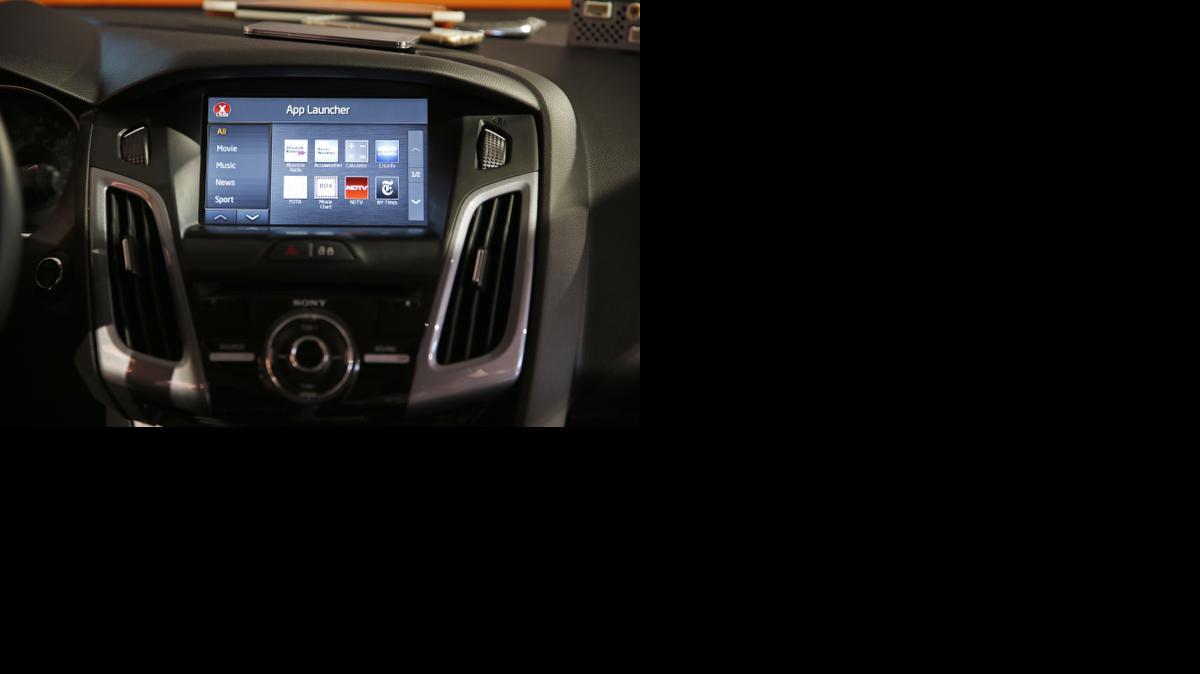 
The OpenAir I1.3 infotainment system is on display in a car at the Visteon booth Thursday, Jan. 8, 2015, at the International CES in Las Vegas. The technology allows you to to access your smart phone and its apps from the touch screen in your car. 
