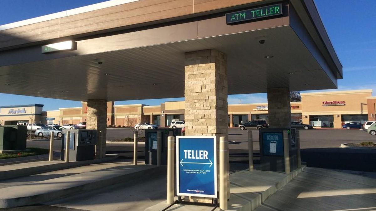 Teller signs in the drive-through lanes at this CommunityAmerica Credit Union mean customers can talk with “video agents” miles away.