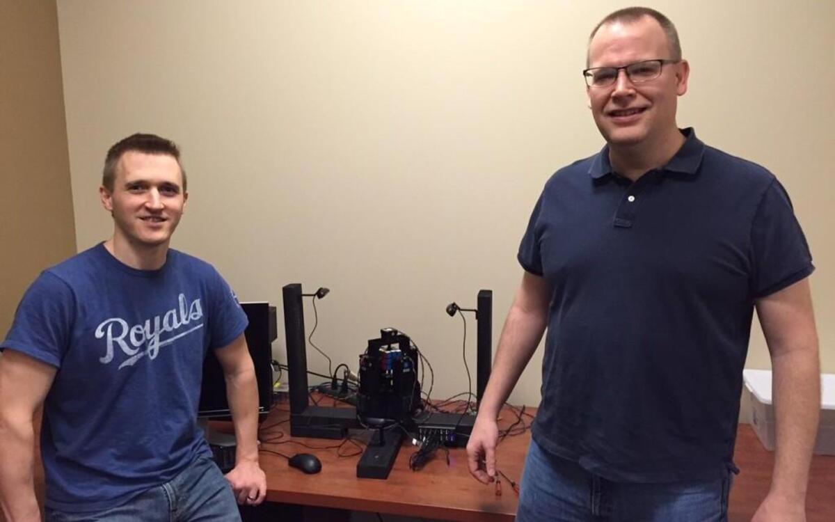 Olathe software developers Jay Flatland (left) and Paul Rose are attempting to set a new Guinness World Record for solving a Rubik’s Cube with a machine. They work together at Tradebot Systems.
