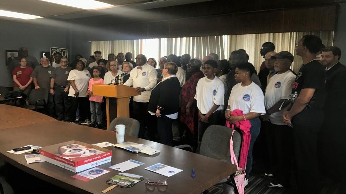 The Rev. Vernon Percy Howard Jr. (at podium) of the Southern Christian Leadership Conference of Greater Kansas City encouraged people to vote to raise the minimum wage in Kansas City at a news conference Thursday at Metropolitan Missionary Baptist Church.