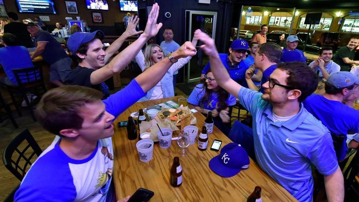 
Royals fans Andy Pence (from left), P.J. Mingos, Fallon O’Reilly, Sadie Wilson and Jacob Weatherford celebrated as Kansas City scored its first run in the Thursday night playoff game against Houston. The friends gathered at the Brooksider to watch the opening game of the ALDS.


