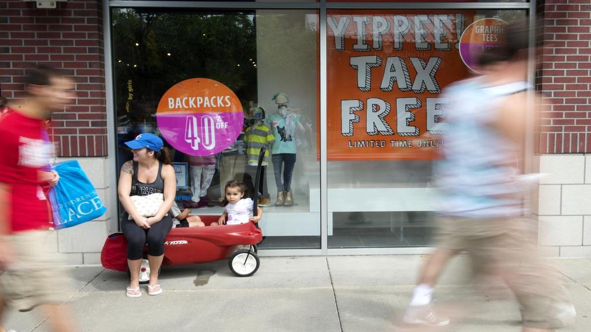 
Samantha Townsend, 4-year-old Anthony Lopez and 2-year-old Juliana Lopez, all from Kansas City, waited outside The Children’s Place on Saturday as Zona Rosa shoppers took advantage of Missouri’s sales tax holiday.
