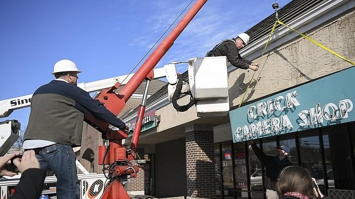 Outside 7715 State Line Road, workers take down the Crick Camera Shop neon sign as the final act of the longtime store’s closing. Local photographer Nick Vedros wants to memorialize the sign and others like it with a neon museum: “I think the community would be interested in preserving that history of Kansas City before it’s too late,” Vedros says.