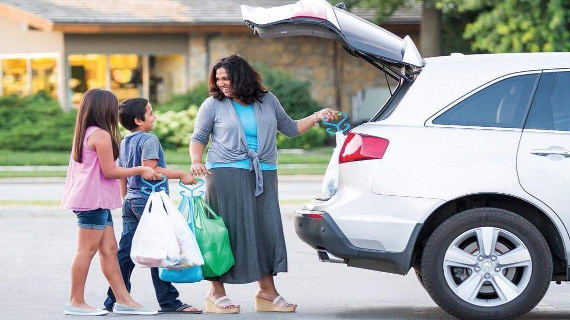 The Mighty Handle allows a user to carry six to eight bags — up to 50 pounds — in one hand.