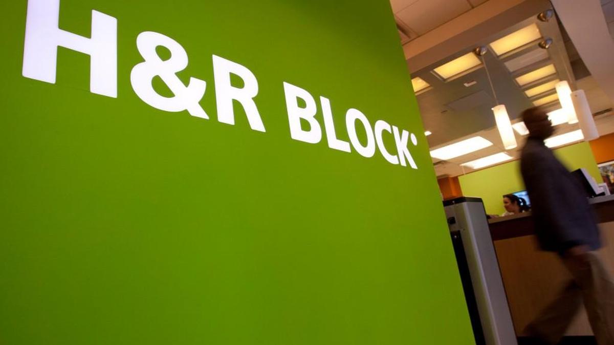 A customer walks past the H&R Block Inc. logo at the company's flagship office in New York, U.S., on Friday, March 2, 2012. H&R Block Inc. provides tax services to the general public and selected Kansas City-based VML as its social media agency.