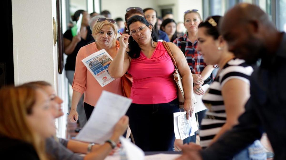 Reina Borges (left) stood in line in July to apply for a job with Aldi at a job fair in Miami Lakes, Fla. More job seekers are finding the work they want, according to July numbers released Friday by the Labor Department.