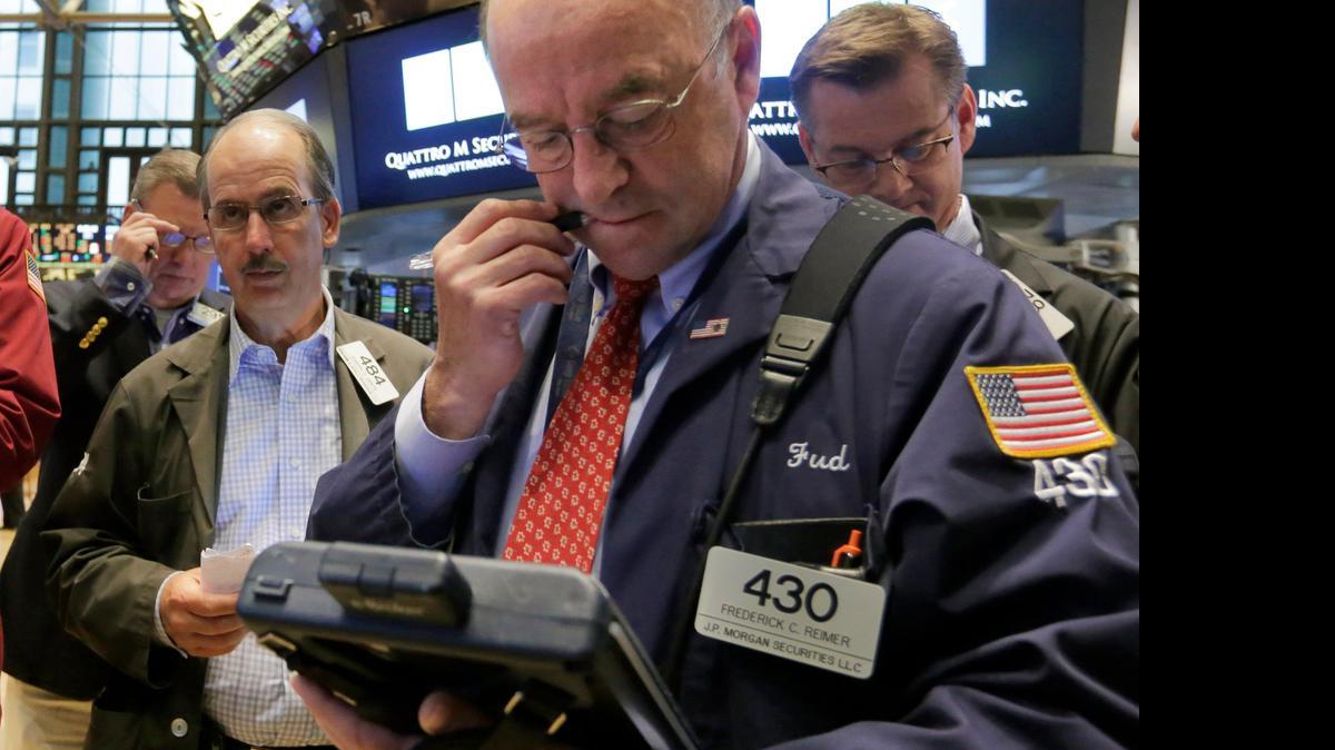 
Frederick Reimer (right foreground) worked Friday with fellow traders on the floor of the New York Stock Exchange. A strong jobs report knocked down U.S. government bond prices Friday, sending yields higher, as traders bet that the Federal Reserve would raise interest rates later this year. 
