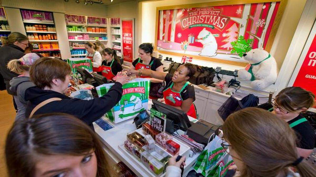 
Clerks, including Fronia Ford (center), were busy Friday morning at the Bath & Body Works in Zona Rosa.
