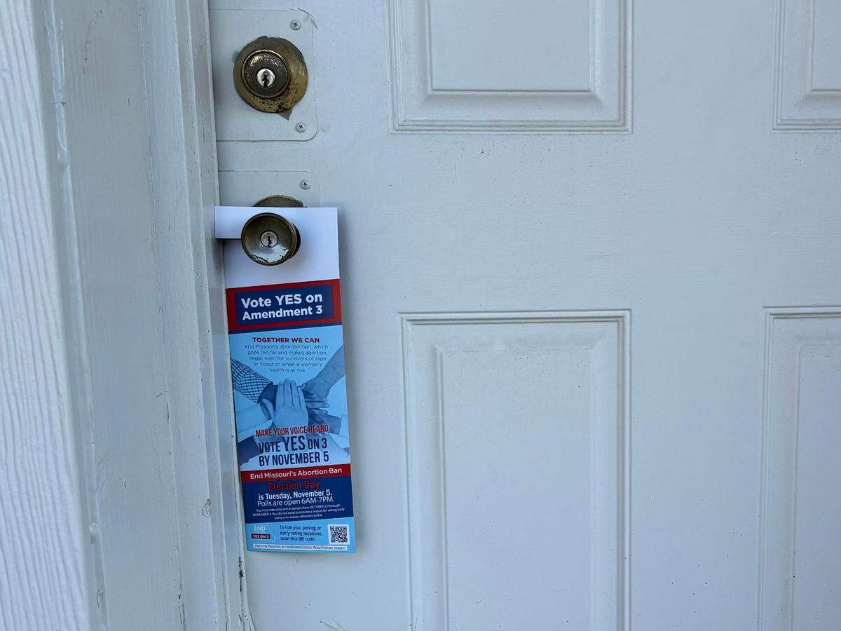 A flier in favor of Amendment 3 in Missouri hangs on a door in Kansas City.
